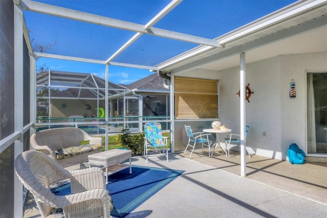 view of patio with glass enclosure and an outdoor hangout area