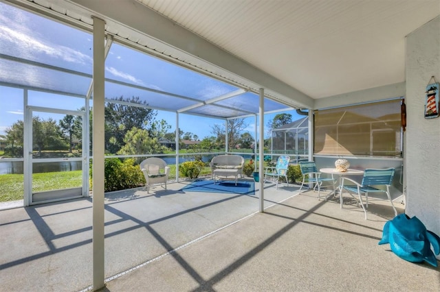 unfurnished sunroom with a water view