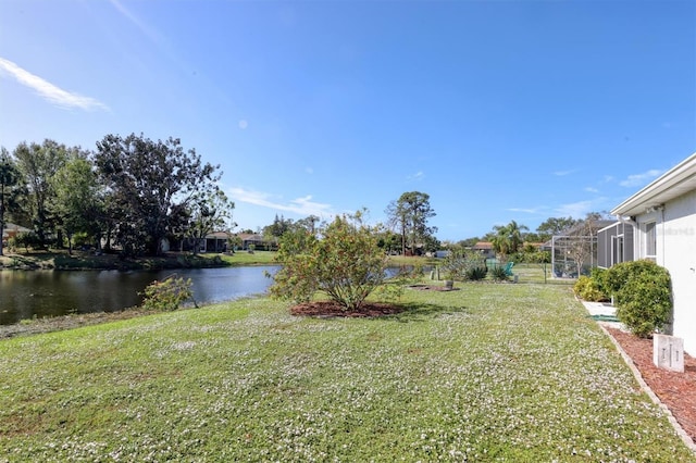 view of yard featuring a water view and a lanai