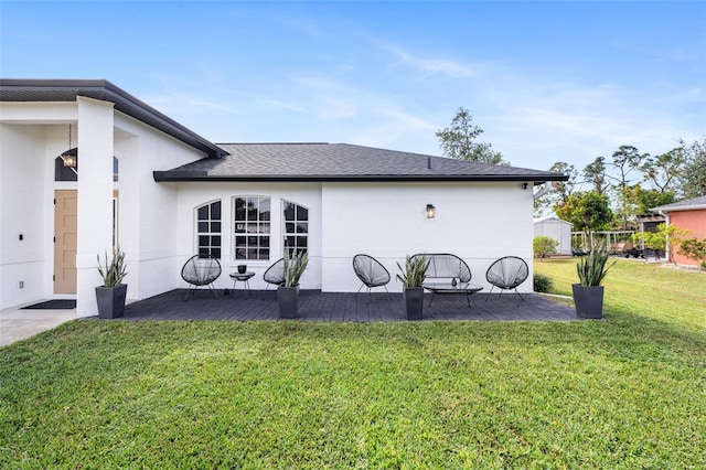 rear view of property featuring a lawn