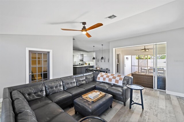 1953 Wheeling Ave, North Port, FL 34288 - living area featuring a ceiling fan, light wood finished floors, and lofted ceiling