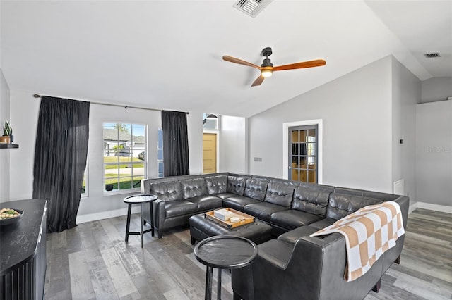 living room with ceiling fan, wood-type flooring, and lofted ceiling