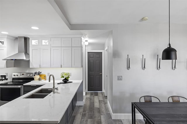 1953 Wheeling Ave, North Port, FL 34288 - kitchen with wall chimney range hood, stainless steel electric range oven, white cabinets, wood finished floors, and recessed lighting