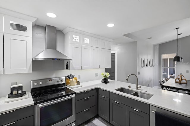 1953 Wheeling Ave, North Port, FL 34288 - kitchen with wall chimney exhaust hood, appliances with stainless steel finishes, white cabinetry, gray cabinetry, and recessed lighting