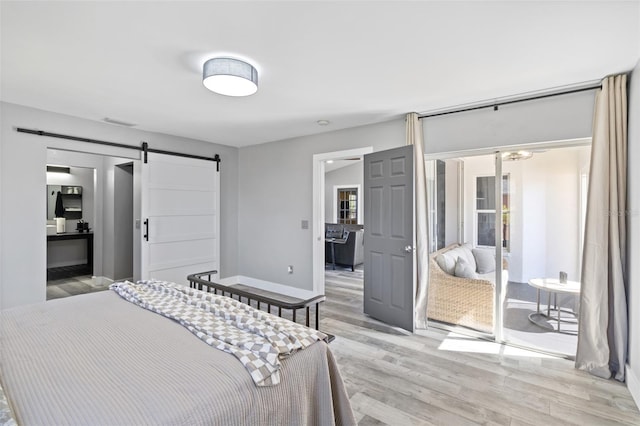 1953 Wheeling Ave, North Port, FL 34288 - bedroom with light wood finished floors, a barn door, and a closet
