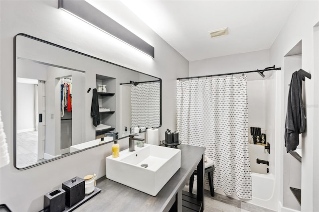 bathroom featuring shower / tub combo, hardwood / wood-style flooring, and sink