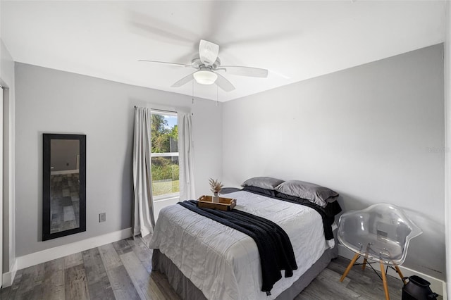 bedroom with ceiling fan and wood-type flooring