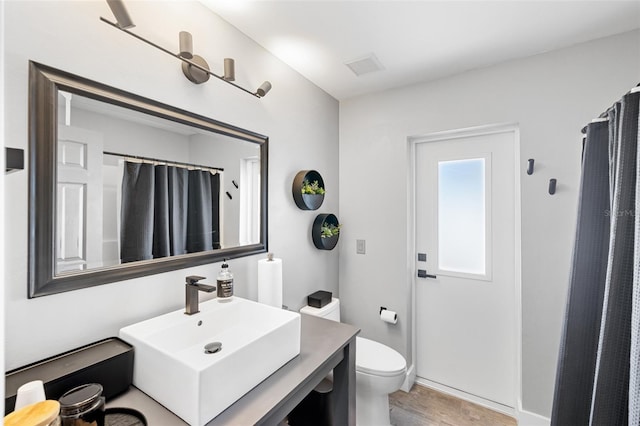 1953 Wheeling Ave, North Port, FL 34288 - bathroom with vanity, curtained shower, and wood finished floors