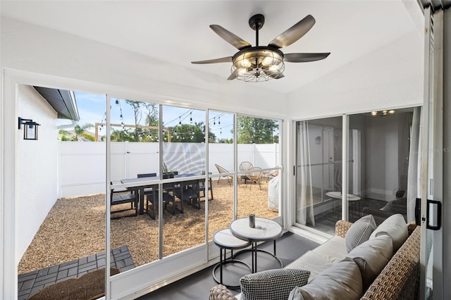 sunroom / solarium with ceiling fan, a healthy amount of sunlight, and lofted ceiling