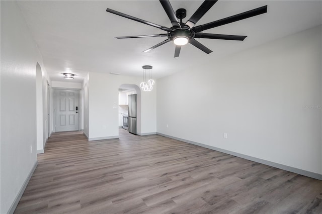 unfurnished living room featuring ceiling fan and light hardwood / wood-style flooring