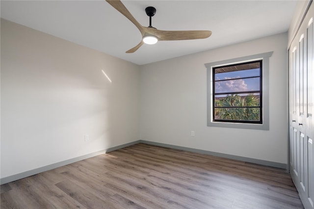 empty room with light wood-type flooring and ceiling fan