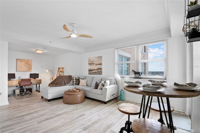 living room with light wood-type flooring, ceiling fan, and crown molding