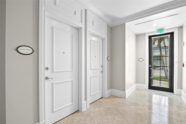 foyer featuring crown molding