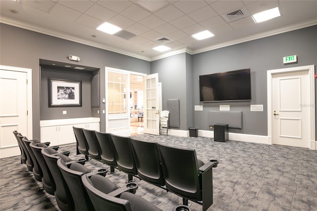 home theater with hardwood / wood-style floors, a drop ceiling, and ornamental molding