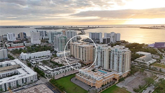 aerial view at dusk with a water view and a view of city