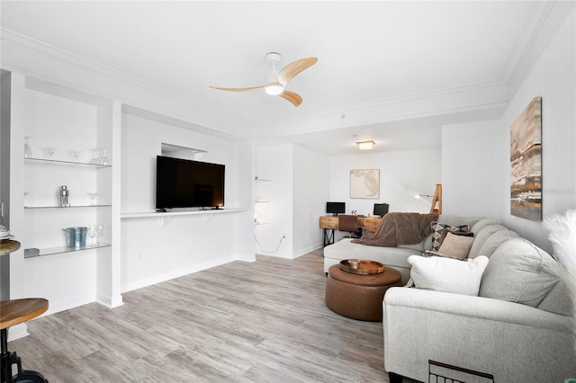 living room featuring ceiling fan, light hardwood / wood-style floors, and ornamental molding