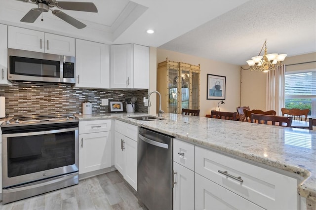 kitchen featuring white cabinetry, sink, appliances with stainless steel finishes, and tasteful backsplash