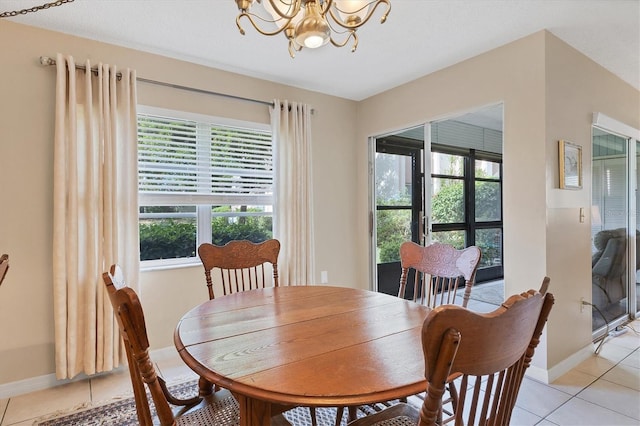 dining space with light tile patterned floors and a notable chandelier