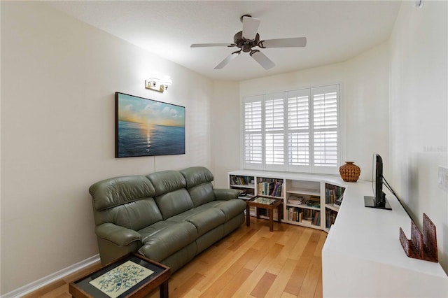 living room featuring wood-type flooring and ceiling fan