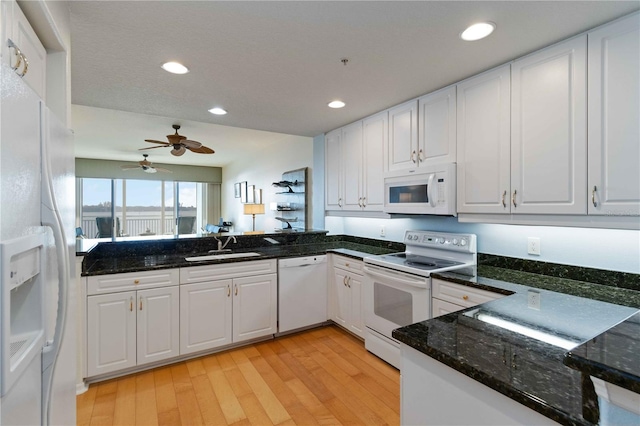 kitchen featuring white cabinets, light wood-type flooring, white appliances, and sink