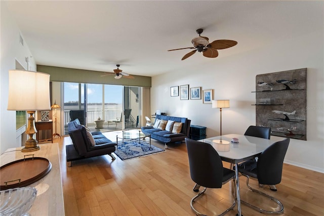 living room featuring light wood-type flooring and ceiling fan