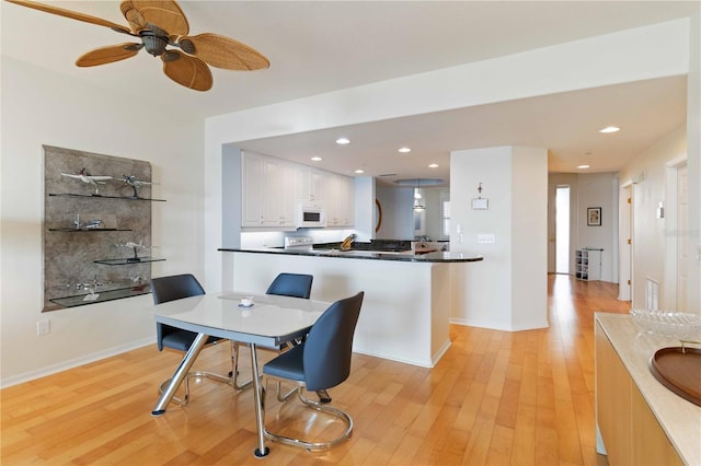 dining area featuring ceiling fan and light hardwood / wood-style floors