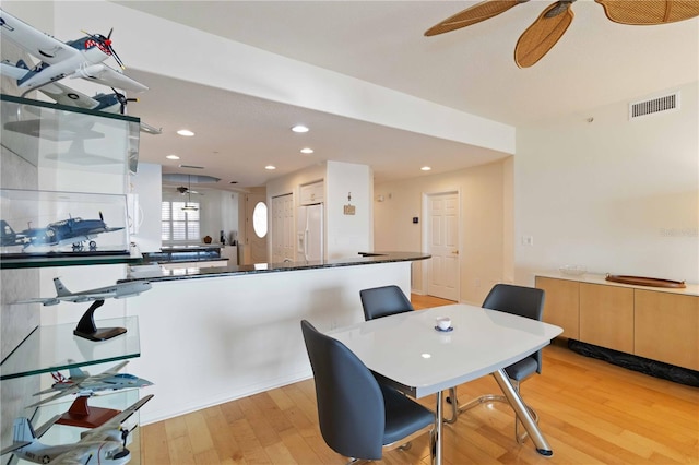 dining room with ceiling fan and light hardwood / wood-style flooring