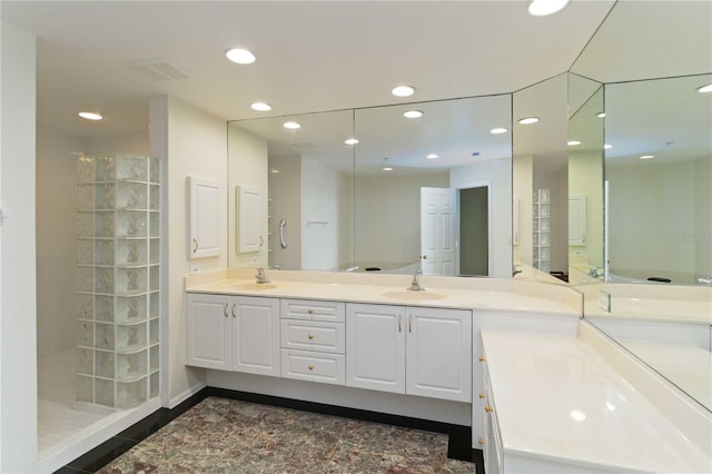 bathroom featuring a shower and vanity