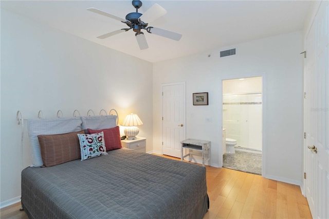 bedroom with ceiling fan, ensuite bathroom, and light hardwood / wood-style floors