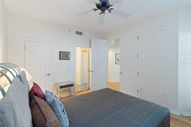 bedroom with ceiling fan and light hardwood / wood-style floors