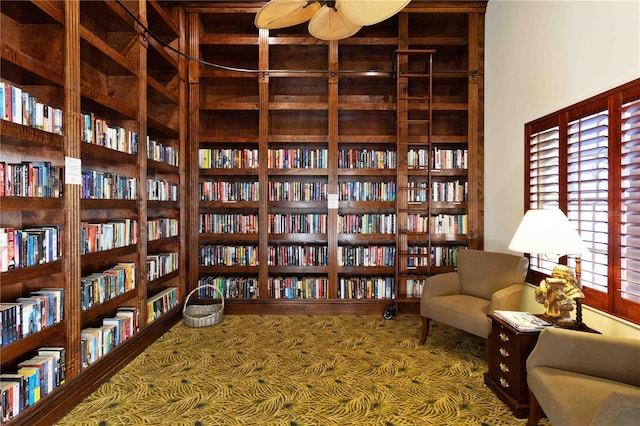 living area with hardwood / wood-style floors and ceiling fan