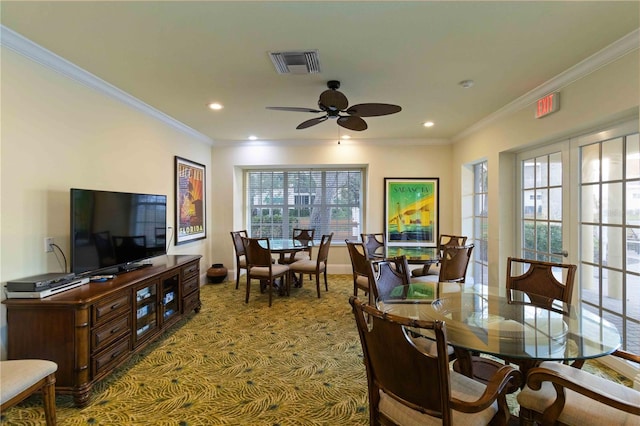 dining space with ceiling fan, crown molding, and a healthy amount of sunlight