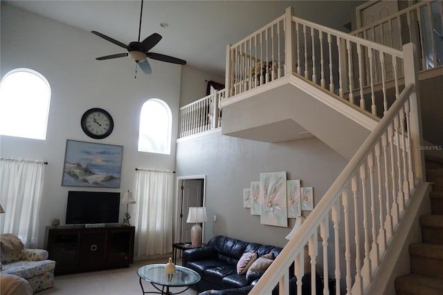 carpeted living room featuring high vaulted ceiling and ceiling fan