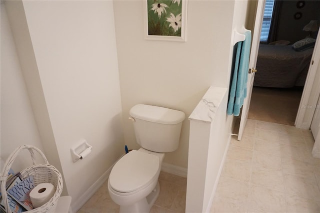 bathroom featuring toilet and tile patterned flooring