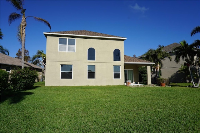 back of house featuring a lawn