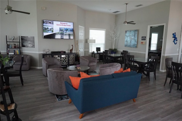 living room with dark wood-type flooring and ceiling fan