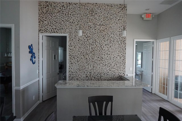 kitchen featuring hardwood / wood-style floors and light stone counters