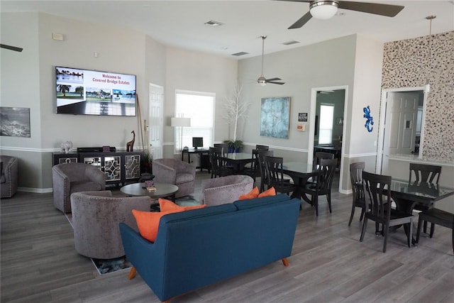 living room featuring ceiling fan and wood-type flooring