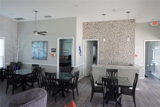 dining area featuring dark wood-type flooring and ceiling fan