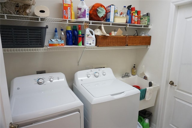 washroom featuring washing machine and clothes dryer and sink