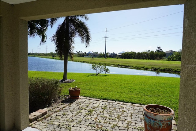 view of yard featuring a patio and a water view