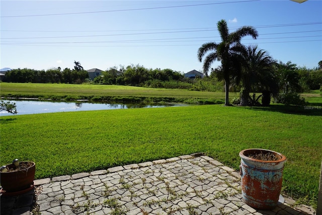 view of yard with a patio and a water view