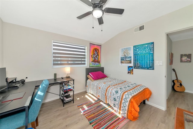 bedroom featuring light hardwood / wood-style floors, vaulted ceiling, and ceiling fan