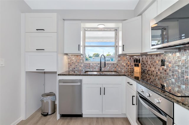 kitchen featuring white cabinets, sink, and appliances with stainless steel finishes