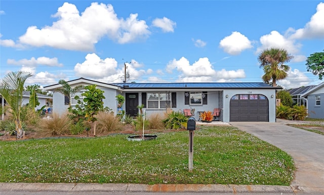 view of front of property with a porch, a garage, and a front yard