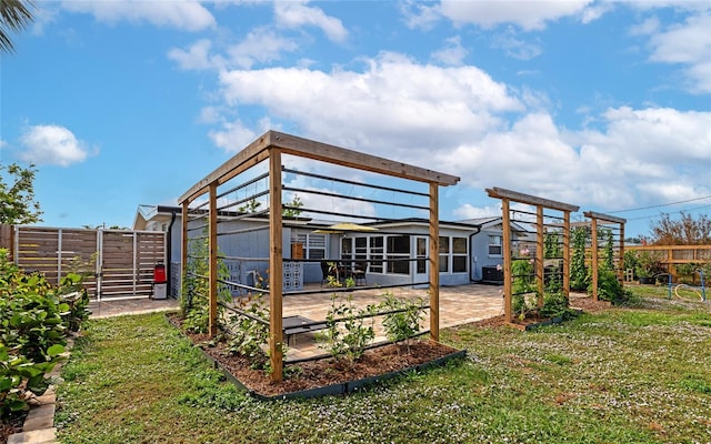 back of property with a patio area and a lawn