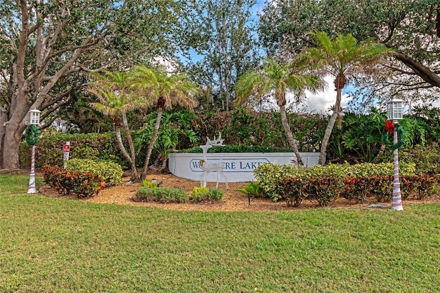 community / neighborhood sign with a lawn