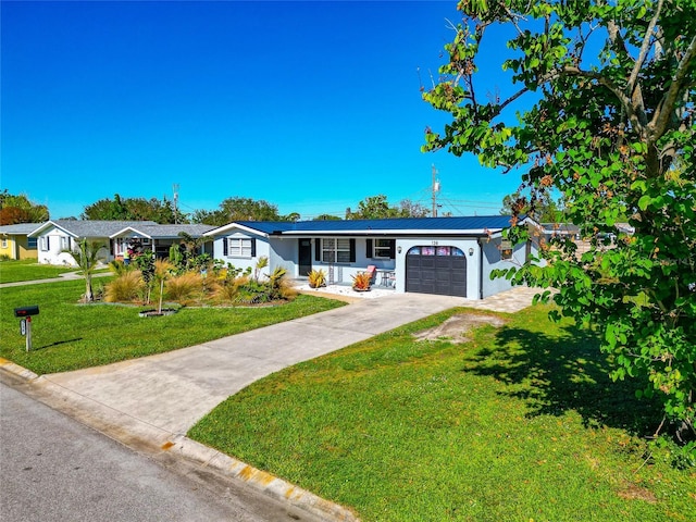 single story home with a porch, a garage, a front yard, and solar panels