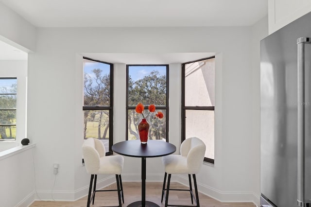 dining space with light hardwood / wood-style flooring