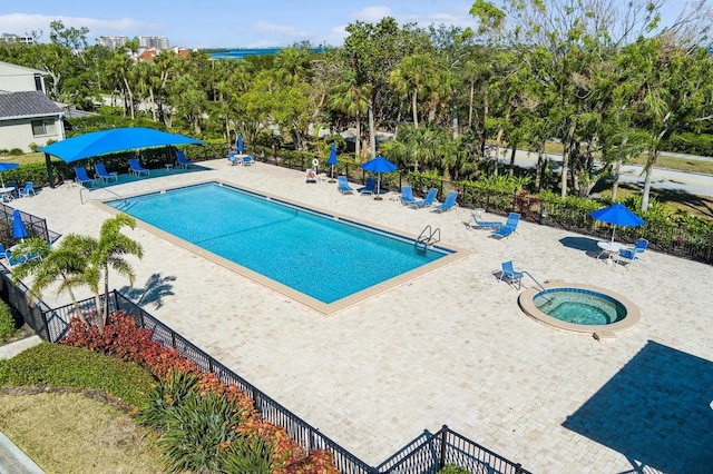 view of swimming pool featuring a community hot tub and a patio